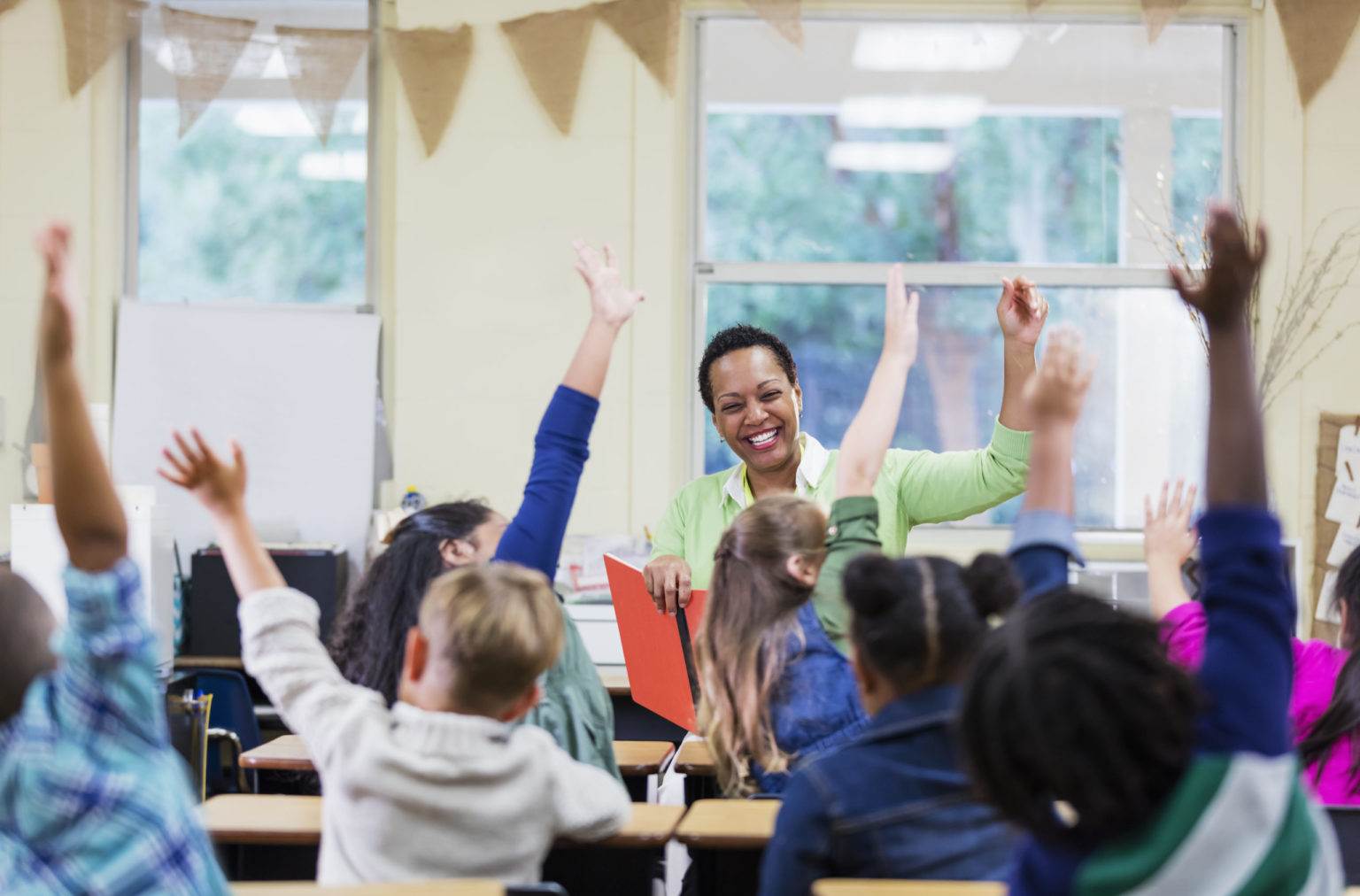 african-american-teacher-reading-to-school-children-economic
